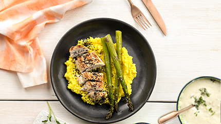 Free-range chicken breast with asparagus on a bed of polenta